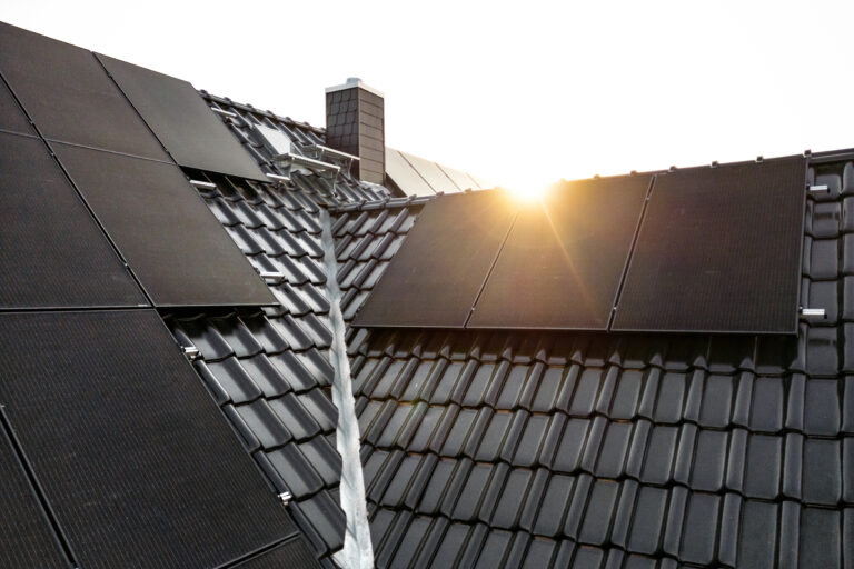 Solarmodule auf einem Ziegeldach tanken Sonnenlicht und gewinnen durch innovative Photovoltaik-Technologie effizient Energie.